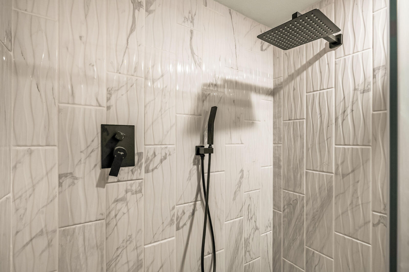 Third bath marble shower with matte black fixtures